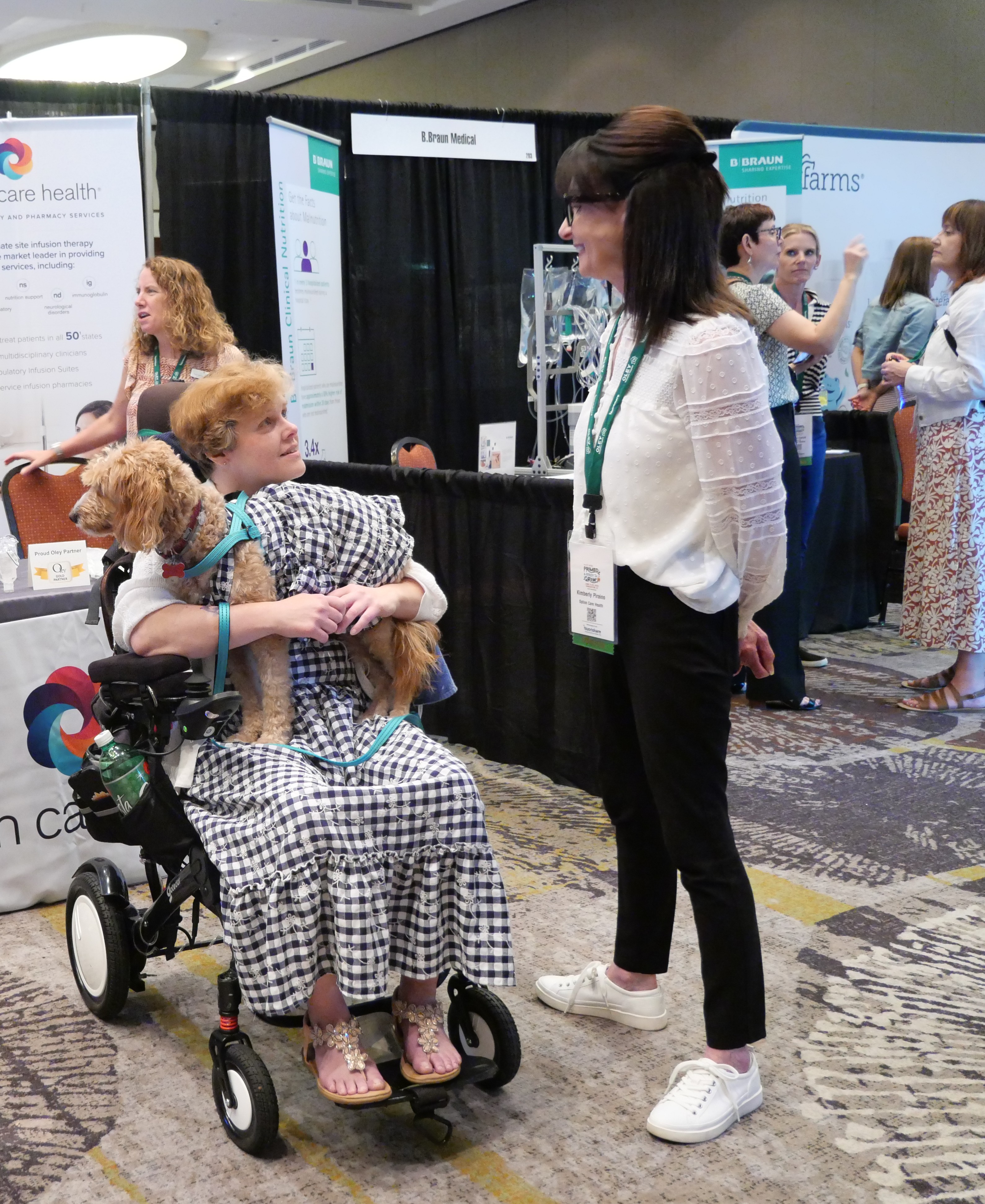 Experience Expo attendee conversation near exhibitor booths