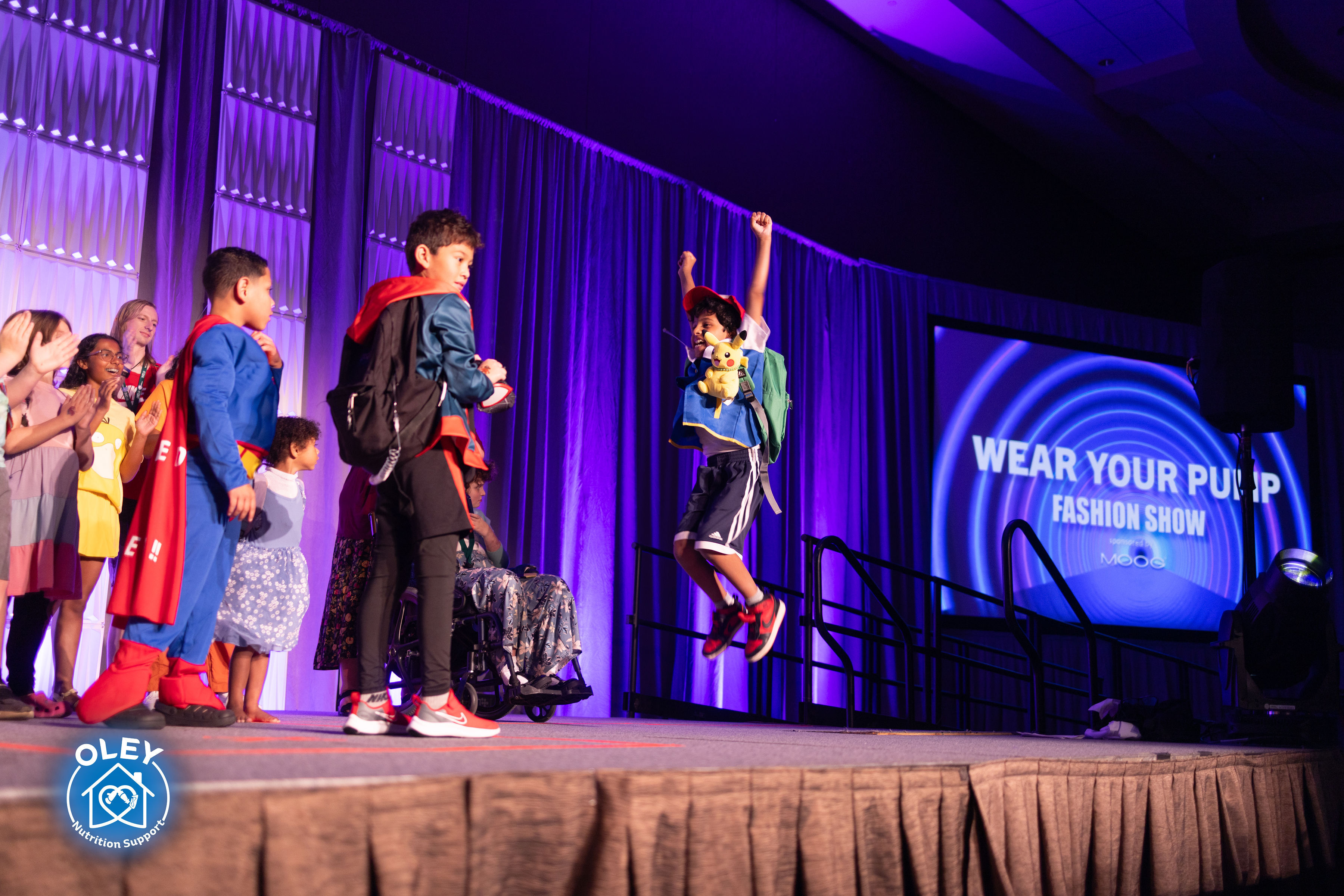 Kids participating on stage during the fashion show
