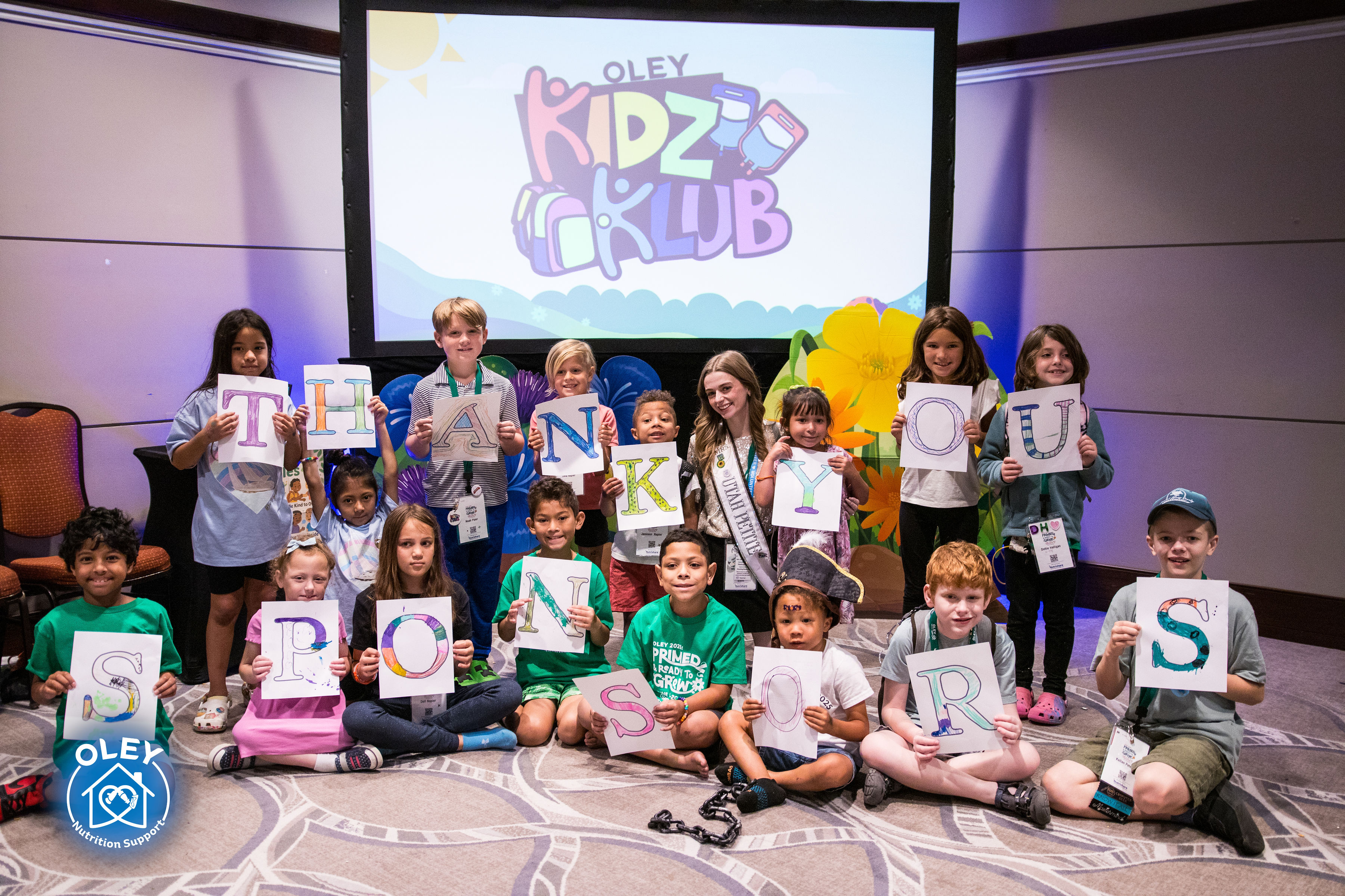 Kidz Klub group photo with kids holding thank you signs