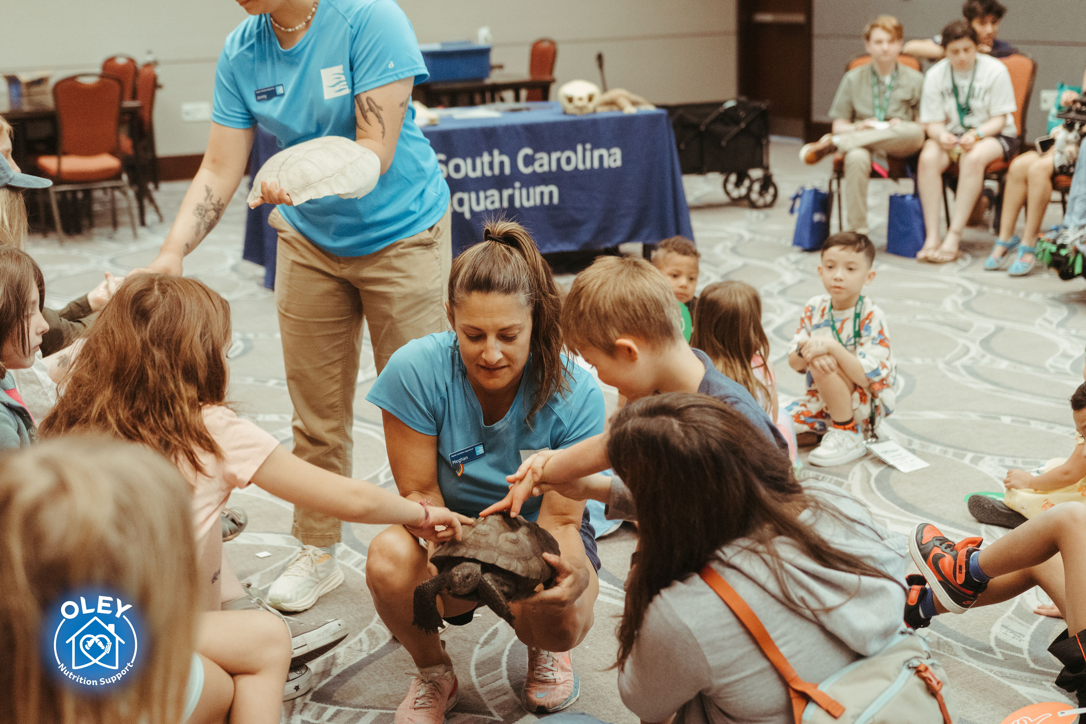 Kids gathered for an interactive learning activity with an animal